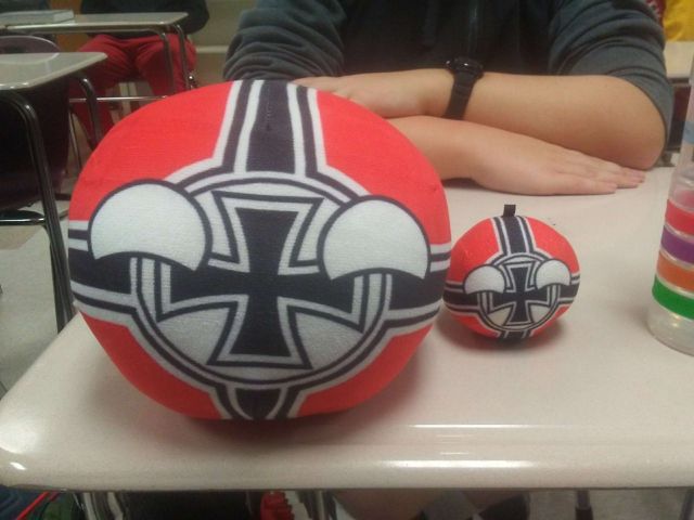 Two countryballs of the Third Reich sitting on a school desk.